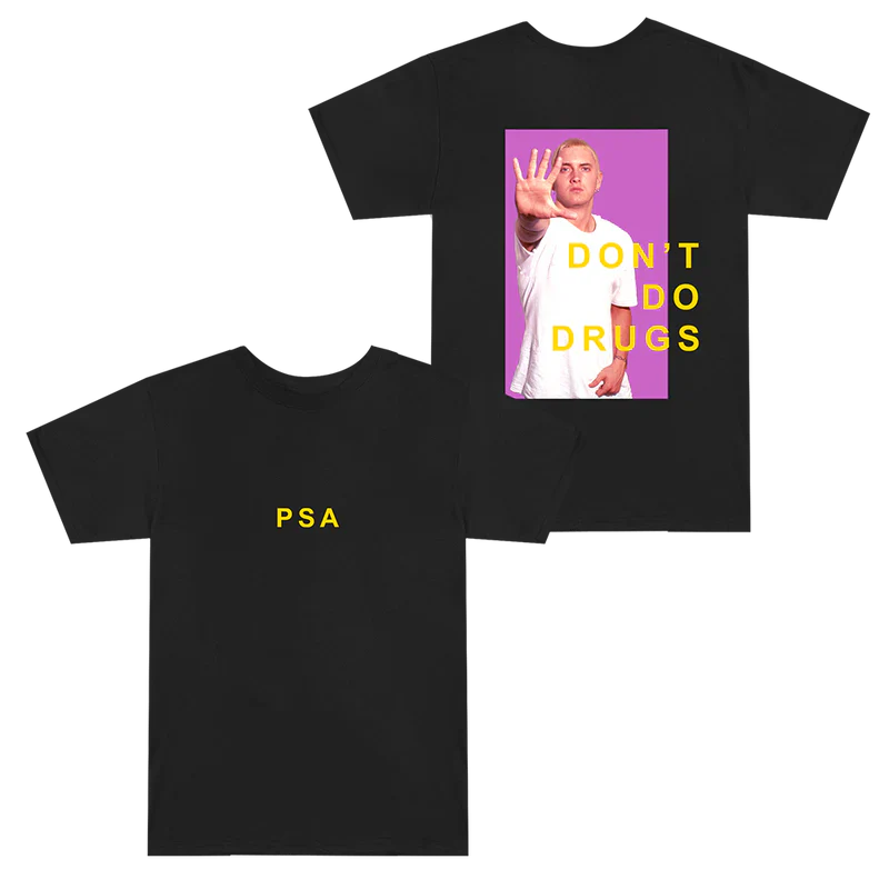 Flat lay of the Eminem SSLP25 PSA black T-shirt showing the striking 'Don't Do Drugs' print with Eminem's image on the back and 'PSA' acronym on the front.