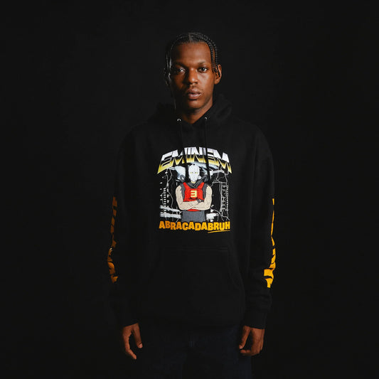 Model wearing the Eminem x Fortnite Rap Boy Reloaded Hoodie in black, featuring bold comic-style graphic of Eminem with lightning background, yellow "ABRACADABRUH" text, and Fortnite sleeve branding.

